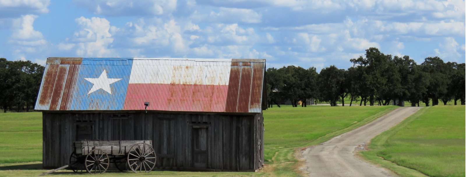 buckboard wagon by a barn
