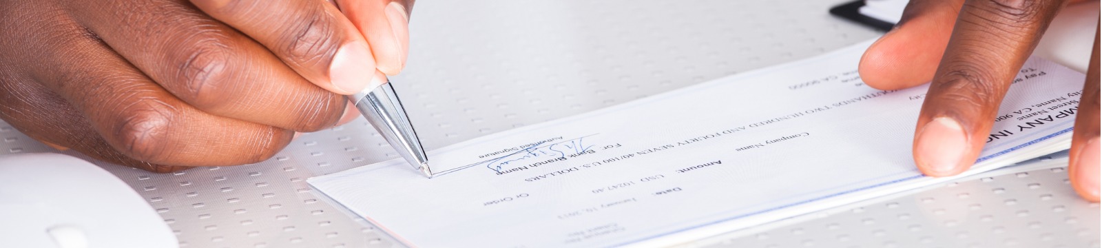 Picture of hands writing a check